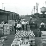 Farmers loading baskets of fruit 1920